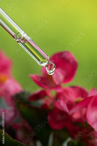 Serum dropper bottle with flower background