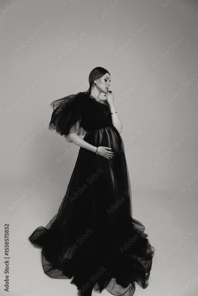 Φωτογραφία beautiful pregnant woman with dark hair in luxurious evening tulle black dress