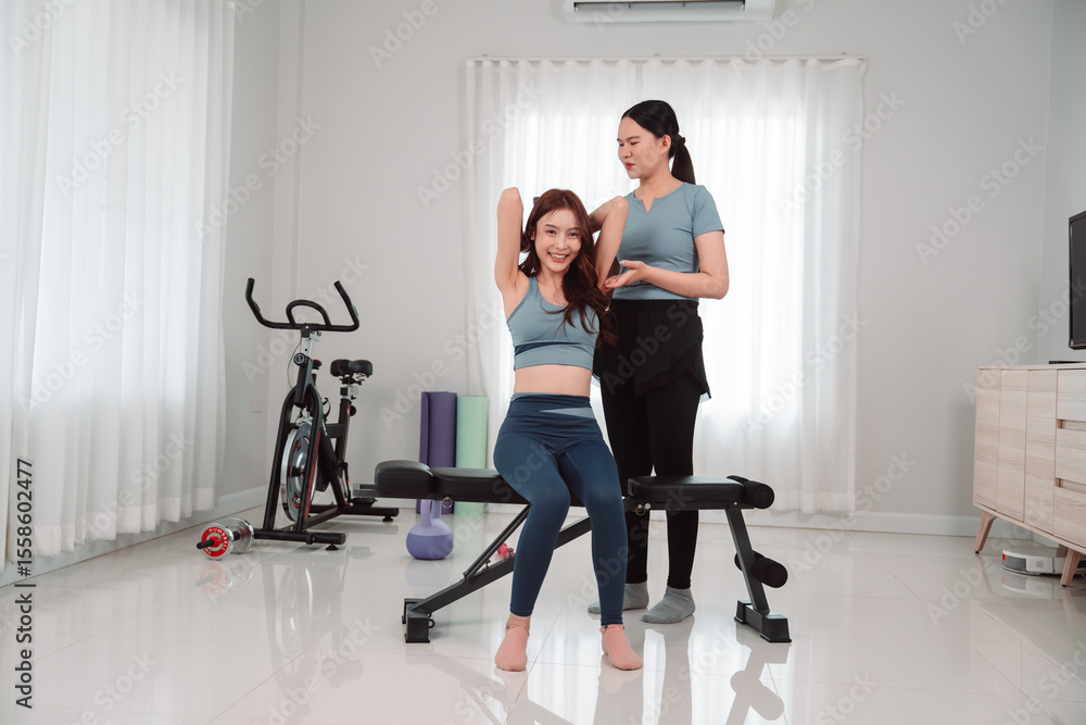 Fototapeta premium Asian Woman Lifestyle Friends Training Fitness Sport Fit Exercise , Two Female Active Enjoying a Healthy Home Workout Routine Together for Wellness, Balance, and Motivation in the Living Room