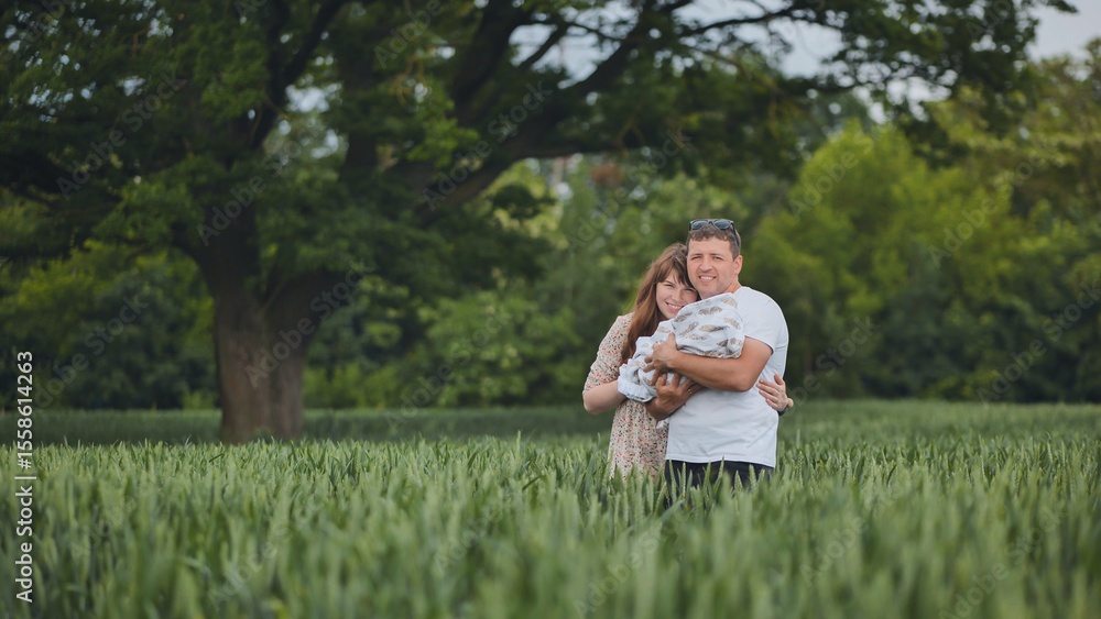 Loving parents cradling newborn infant amid lush green meadow, sharing tender family connection Loving parents cradling newborn infant amid lush green meadow, sharing tender family connection