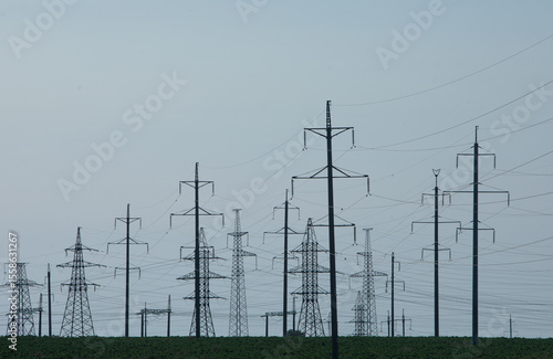 High voltage power lines and pylons against blue sky. Electric tower. Power transmission lines. Energy security and clean energy.  