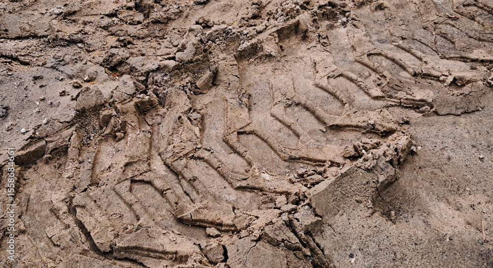 Tire track of heavy machinery in soft soil, close-up view Tire track of heavy machinery in soft soil, close-up view