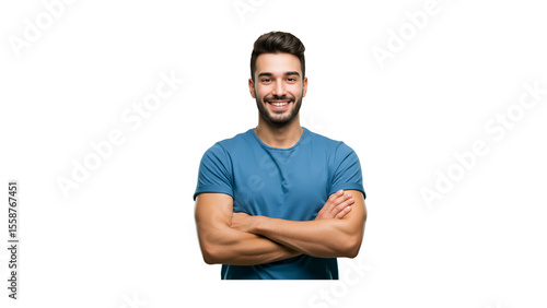 Indoor portrait of young european man standing in blue t-shirt with crossed arms, smiling and looking at camera