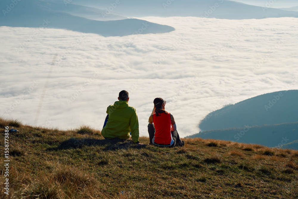 Fototapeta premium Couple in Love Enjoying the View at the Top of a Mountain.
