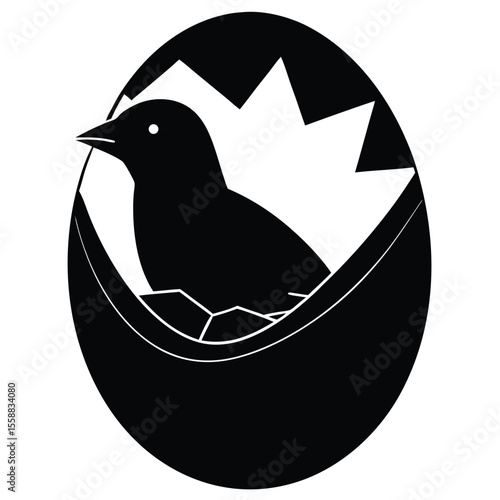 Black silhouette of a newly hatched bird emerging from a cracked eggshell