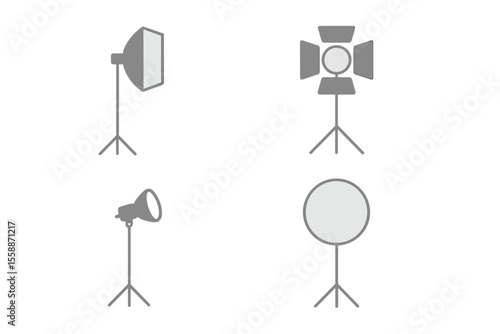 Studio lighting equipment displays various types of lights and reflectors used in photography and videography setups