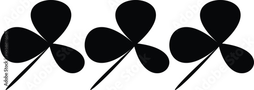 Three black silhouettes of shamrocks lucky charms