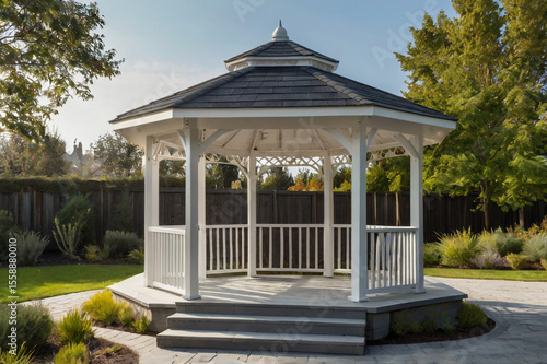 White octagonal gazebo with dark roof and wooden deck image