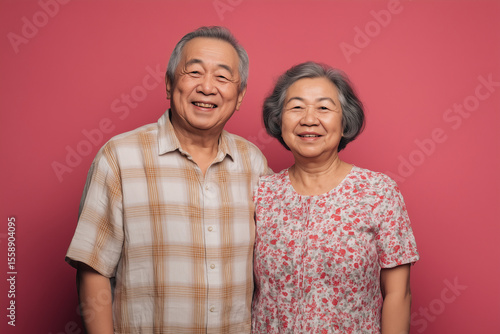 Asian Chinese or South East Asian grandparents in their 70s smiling and happy, natural looking, casual look, waist up photo