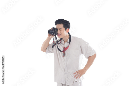 Photographer Taking Photo: A young man, casually dressed, attentively looks through his camera, capturing a moment. His relaxed posture suggests a hobby or passion.