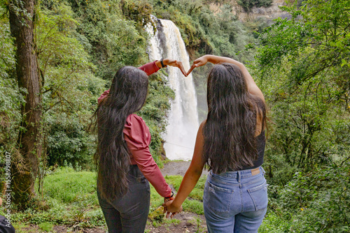 Tourists observing the Kimsa Waterfall, located in the Rumiñahui canton, 15 kilometers from Sangolquí, in the Molinuco Ecological Reserve, Ecuador. The waterfall is approximately 60 meters high.