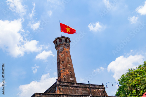 Hanoi flag tower with Vietnamese flag on top. This tower is one of the symbols of the city and part of the Hanoi Citadel, a World Heritage Site. A well known destination for tourist. Panoramic style