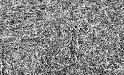 Festive shiny silver tinsel background. The texture of sliced ​​crumpled foil.