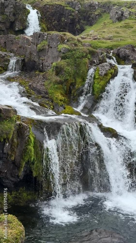 Kirkjufellsfoss waterfall, located near the iconic Kirkjufell mountain in Iceland. Cascading streams, mossy rocks, and cinematic beauty from the Game of Thrones landscape.