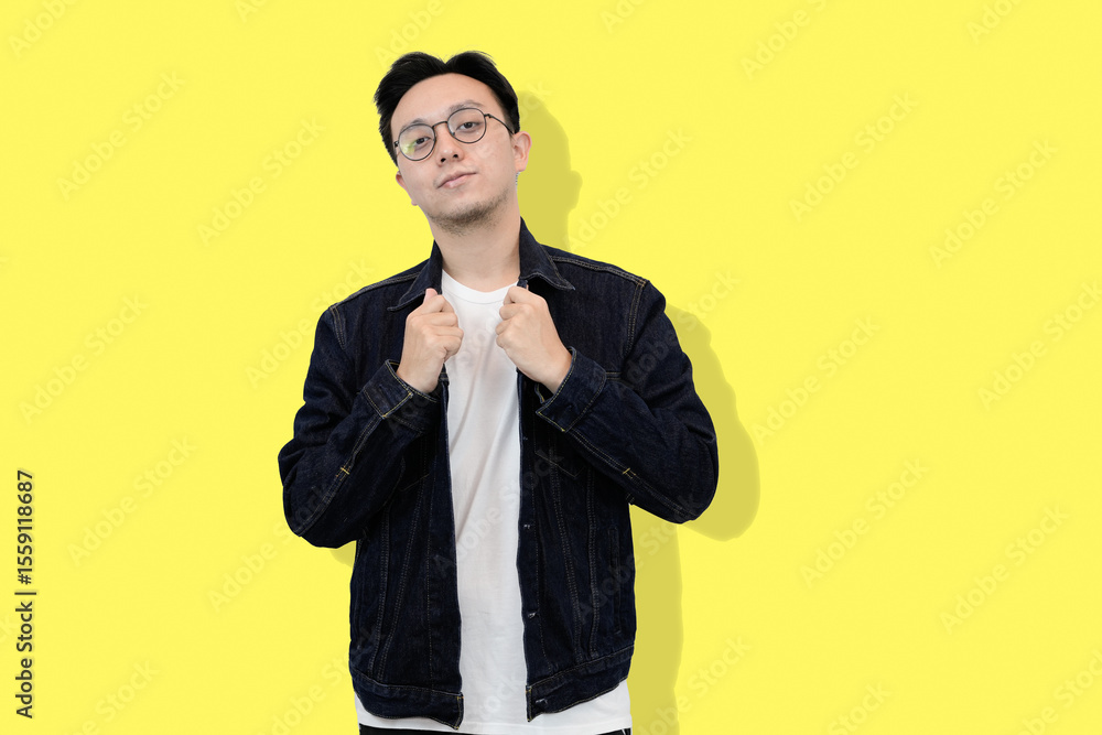 young asian man casual pose in yellow isolated background young asian man casual pose in yellow isolated background