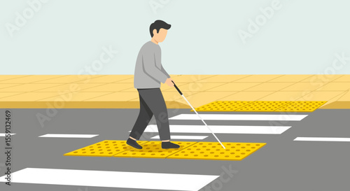 Person with a white cane crossing a pedestrian crossing with tactile paving.