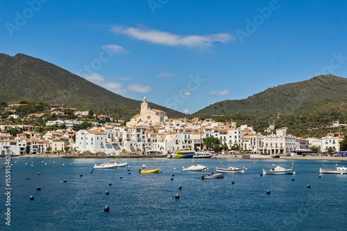 Charming Cadaqués, with small boats, white houses and vibrant blue sky, showcasing the historic Mediterranean coastal town’s beauty and traditional architecture