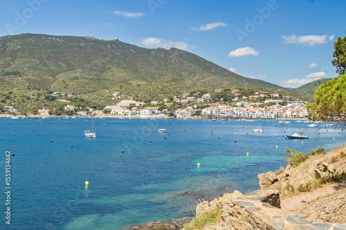 Charming Cadaqués, with small boats, white houses and vibrant blue sky, showcasing the historic Mediterranean coastal town’s beauty and traditional architecture