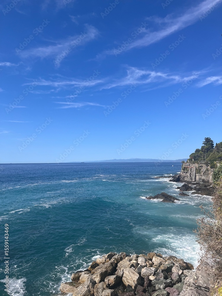 Fototapeta premium Bogliasco, Italy — charming coastal village with colorful houses, peaceful beaches, Mediterranean Sea views, lush hills, and authentic Italian Riviera charm.