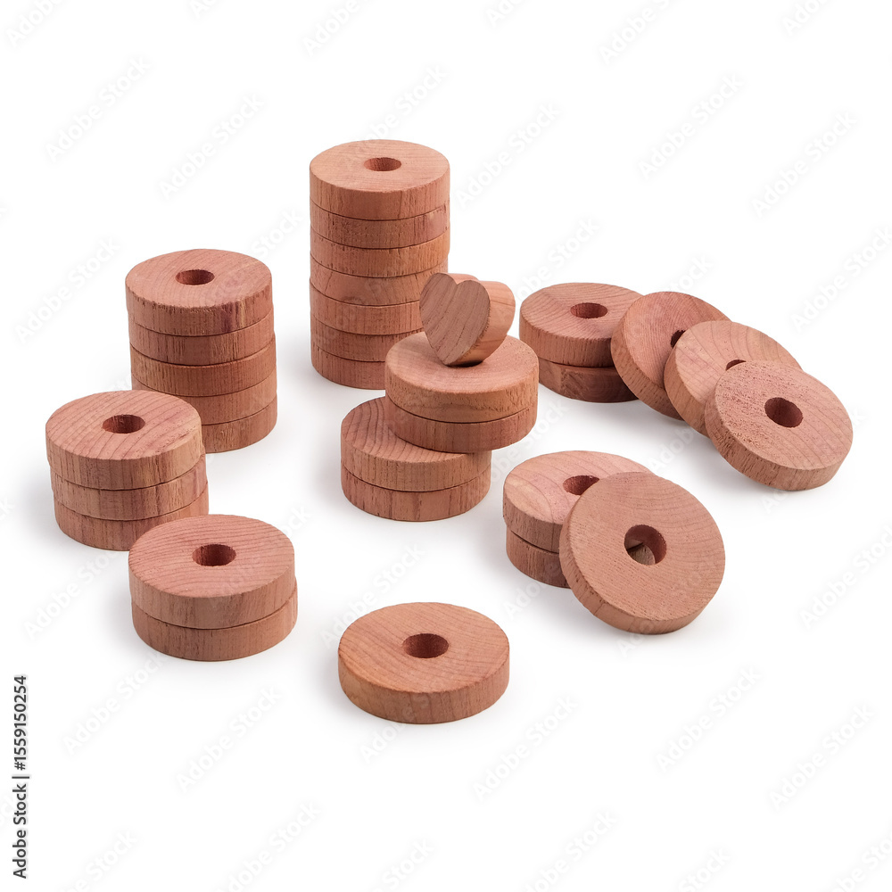 Fotografie Multiple cedar wood discs arranged in stacks and scattered on a white background