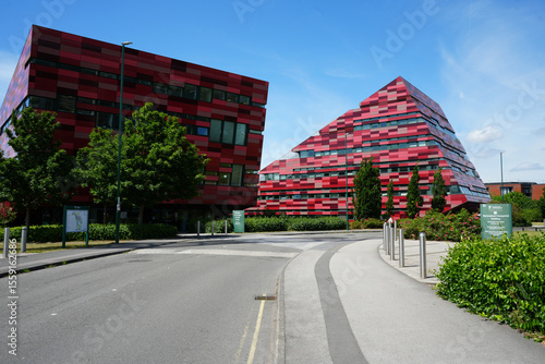 Nottingham, England - June 20 2025: Modern architectural scene featuring two striking buildings with a red and pink checkered facade at Jubilee Campus of the University of Nottingham.