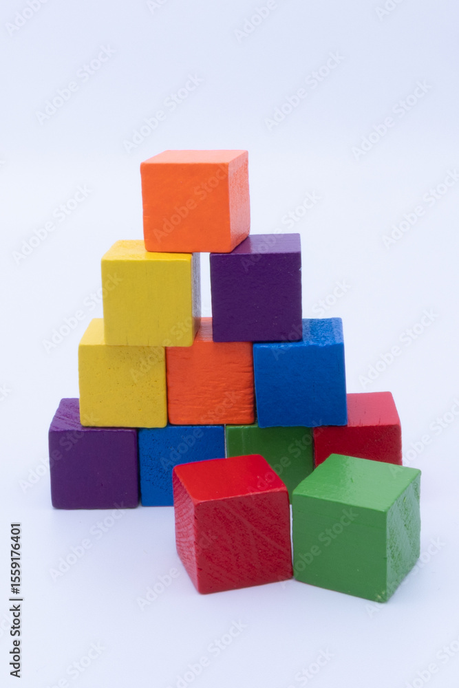A Vibrant Pyramid of Wooden Blocks with Loose Cubes on a White Background A Vibrant Pyramid of Wooden Blocks with Loose Cubes on a White Background