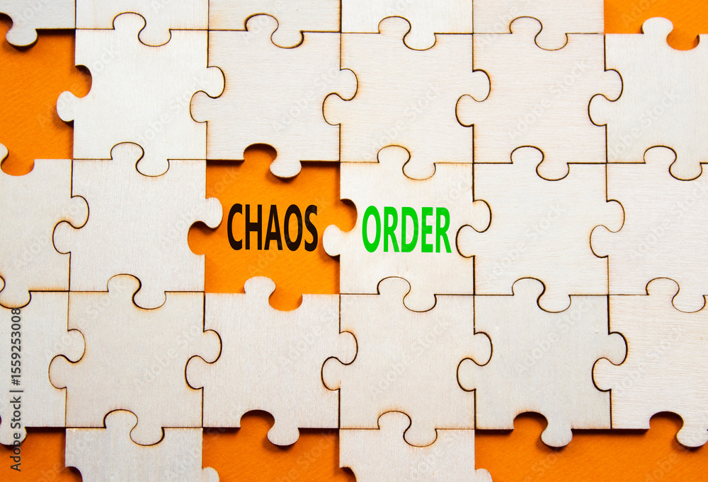 Fototapeta premium Chaos or Order symbol. Concept word Chaos or Order on wooden puzzle. Beautiful orange background. Business and Chaos or Order concept. Copy space