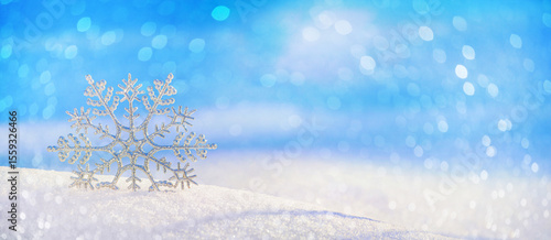 Christmas winter background, banner - view of decorative snowflake in sparkling snow, copy space for text