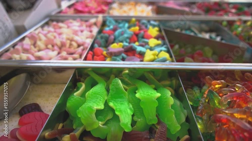 Gummies candy shop market. Crocodile gummy candies close up. Muontain of candy inside a market. Lots of colorful candies. Cola flavor kandy. Multicolored fruit candies