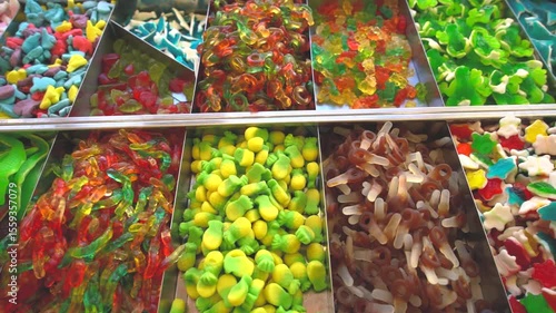 Gummies candy shop market. Crocodile gummy candies close up. Muontain of candy inside a market. Lots of colorful candies. Cola flavor kandy. Different shapes fruit candies