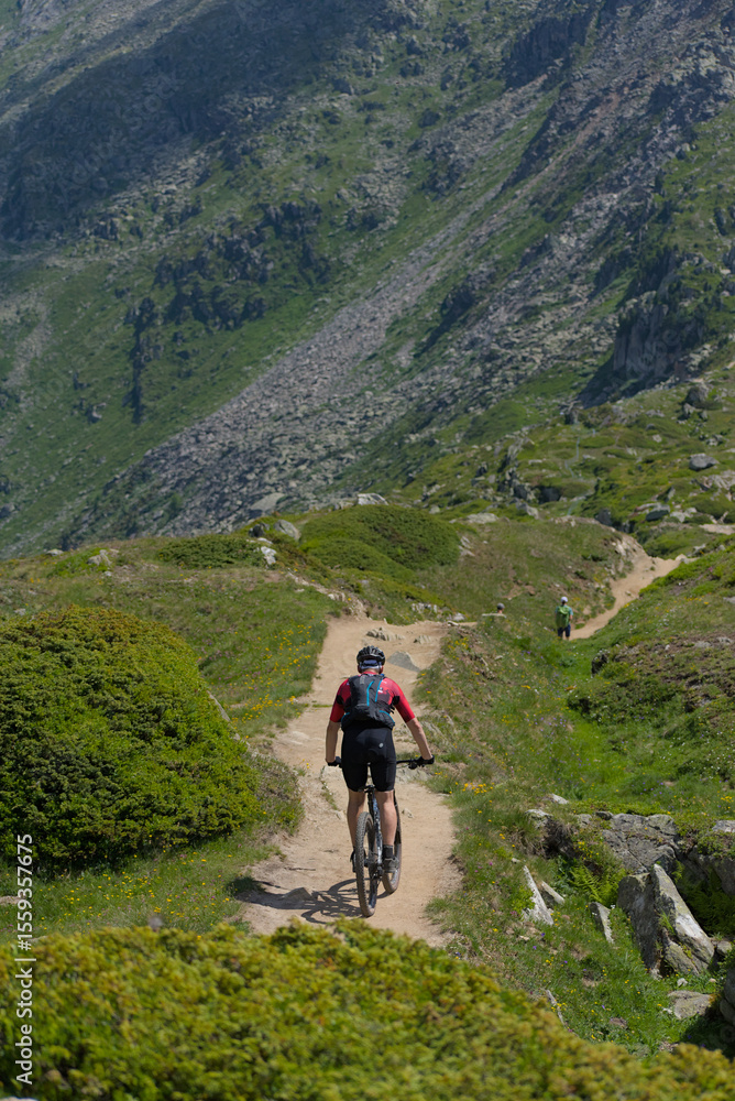 Experience mountain biking adventure! A cyclist conquers a rugged mountain trail under a bright sky, embodying the thrill of outdoor sports and exploration in a stunning alpine landscape. Experience mountain biking adventure! A cyclist conquers a rugged mountain trail under a bright sky, embodying the thrill of outdoor sports and exploration in a stunning alpine landscape.