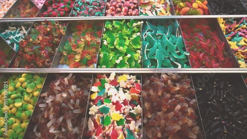 Gummies candy shop market. Crocodile gummy candies close up. Muontain of candy inside a market. Lots of colorful candies. Cola flavor kandy. Different shapes fruit candies