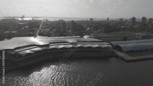 rial drone footage of a luxury cruise ship docked at Colón 2000 port in Panama. The scene captures the massive vessel against the Caribbean Sea backdrop, surrounded by port infrastructure and coastal 