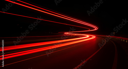 Night road with long exposure showing red light trails of passing vehicles
