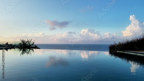 4K drone footage of a luxury infinity pool on a cliff with sweeping ocean views in Asia. Cinematic, tropical travel content showing architecture and nature in harmony.
