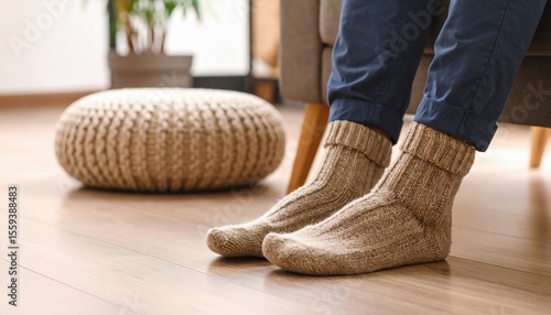 Warm Knitted Socks On Feet In Living Room