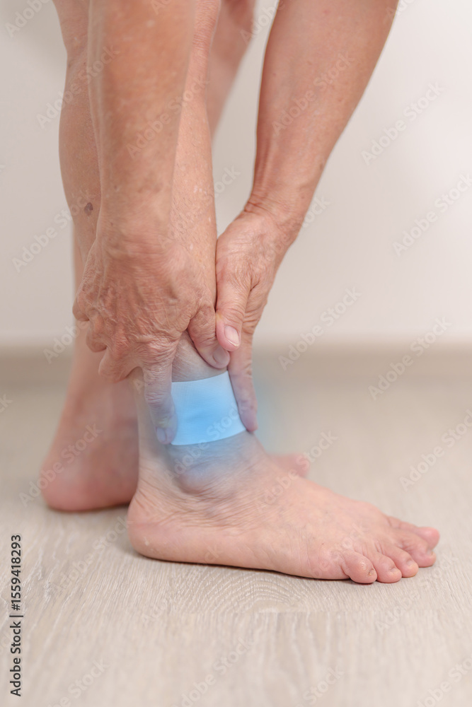 Elderly woman having leg pain with Medicated pain relief patch plaster for Ankle Sprains or Achilles Tendonitis and Shin Splints ache. injury, hyperuricemia disease, Gout and Senior Health care Elderly woman having leg pain with Medicated pain relief patch plaster for Ankle Sprains or Achilles Tendonitis and Shin Splints ache. injury, hyperuricemia disease, Gout and Senior Health care