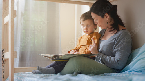 Mother teaching toddler to read during a calm afternoon at home