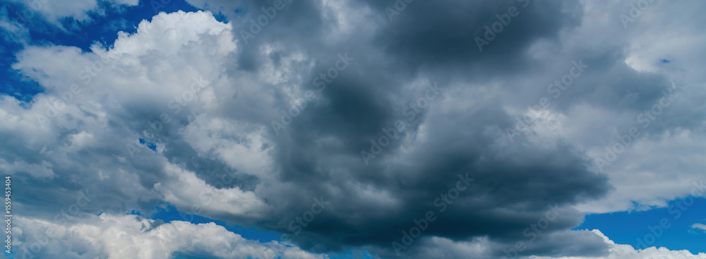 Fototapeta premium Banner Dramatic dark storm clouds black sky background. Dark thunderstorm clouds rainny season. Panorama Meteorology danger windstorm disasters climate. Dark cloudscape storm cloud with copy space.