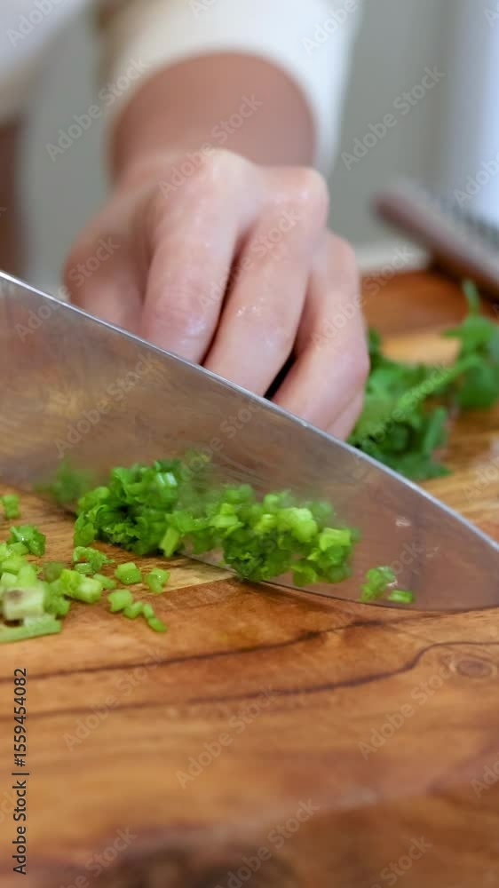 Close-Up of Chopping Fresh Green Herbs on Wooden Board Close-Up of Chopping Fresh Green Herbs on Wooden Board