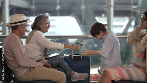 Asian multigenerational family at airport traveling with kids and grandparents, joyful moments of vacation, family holiday trip with luggage before flight, tour, friendly airline, hotel for families