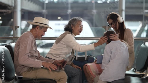Asian multigenerational family at airport traveling with kids and grandparents, joyful moments of vacation, family holiday trip with luggage before flight, tour, friendly airline, hotel for families