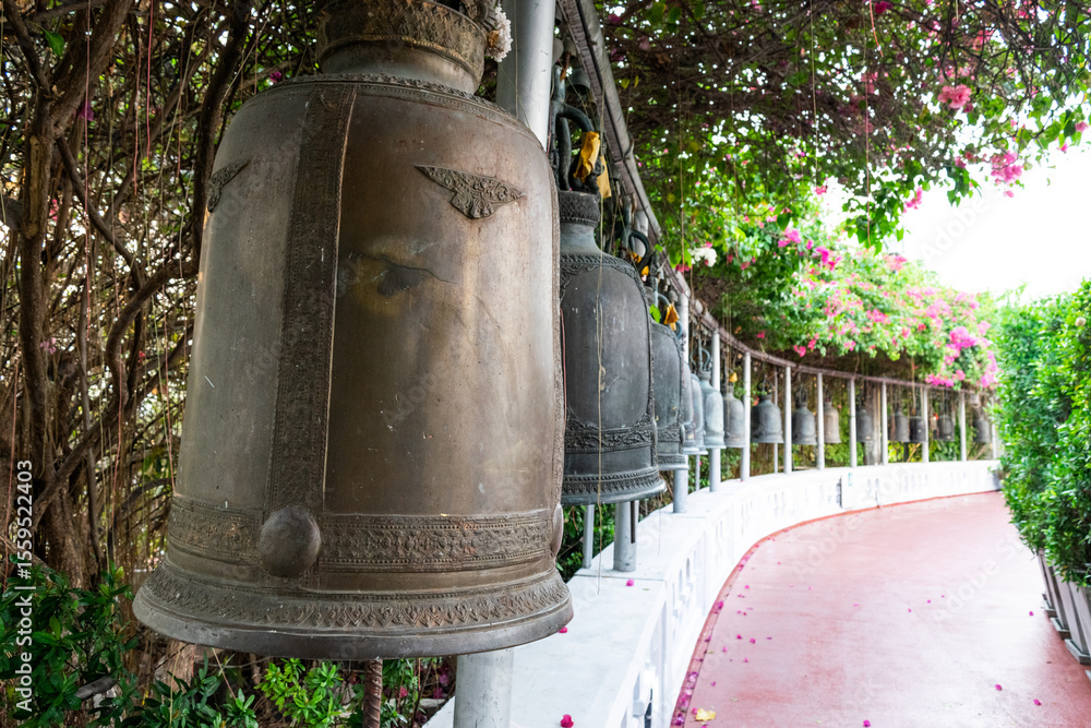 Fototapeta premium Bells hanging in a row in the golden mount temple in bangkok, thailand