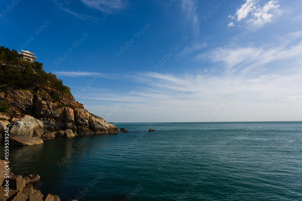 Calm blue sea and seaside rocks Calm blue sea and seaside rocks