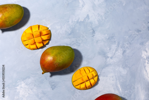 Fresh ripe mangoes on light...