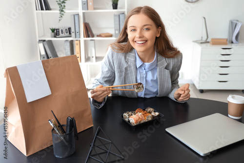 Happy young woman eating su...