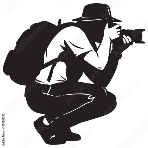 Silhouette of a photographer squatting down with a camera backpack and hat