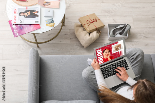 Woman with laptop shopping ...