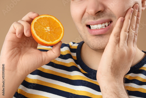 Young man with orange suffe...