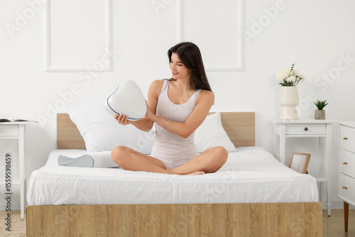 Young woman in pajamas hold...